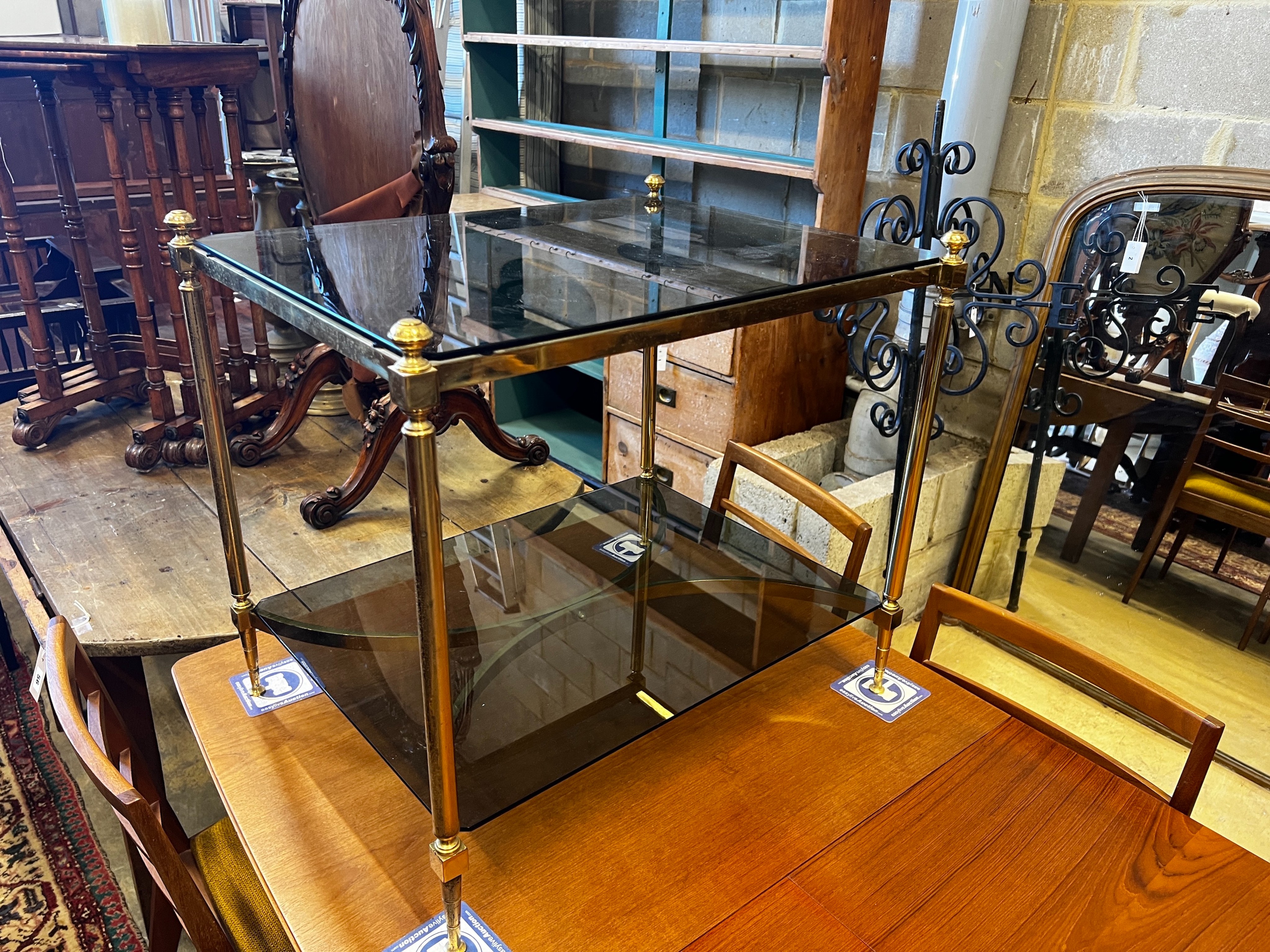 A pair of rectangular brass and black glass two tier tables, width 65cm, depth 50cm, height 59cm